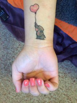 This adorably cute elephant tattoo symbolizes childhood, love and the relationship between mother and child.