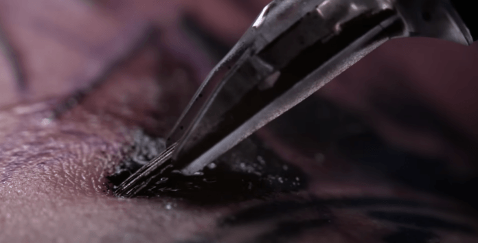 This picture shows how the human skin depresses under the pressure of the tattoo needles before the needles actually break the skin and deliver their payload of ink