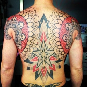 Using only black and red ink, tattoo artist Marco Galdo inks a back tattoo that is both and optical illusion and a fusion between spiritual art and graphic design