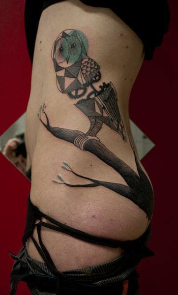 A clock work owl is the time keeper of this torso tattoo by Expanded Eye