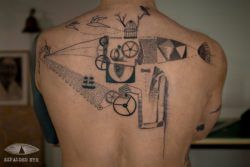 Vintage symbols make up this abstract back tattoo by Expanded Eye
