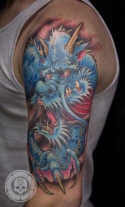 A blue Japanese dragon stalks the viewer in this tattoo by Ben Shaw