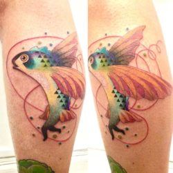 A colorful flying fish is totally confused about whether it should swim, walk or fly. Tattoo by Amanda Chamfreau