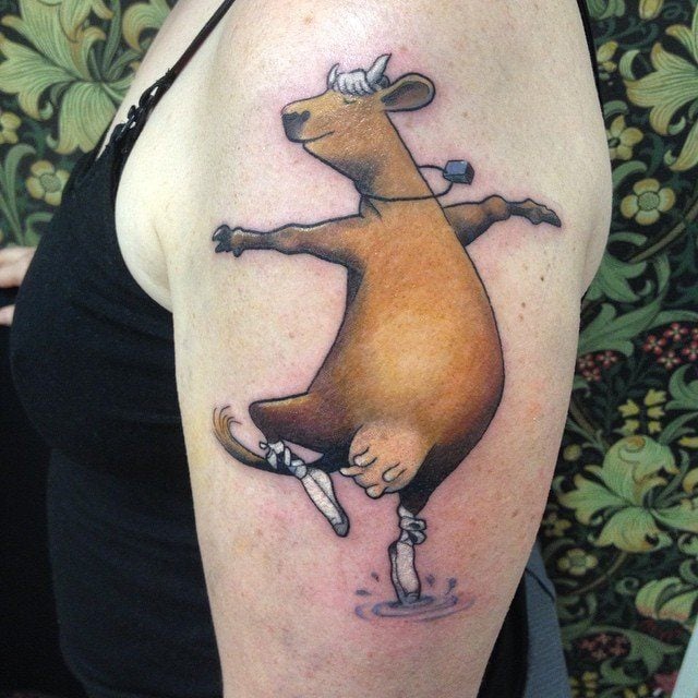 A happy cow finds her zen through ballet dancing in this cheerful tattoo by Amanda Chamfreau