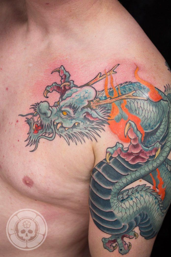 Adding bright colours to this Ben Shaw tattoo doesn't make this dragon any less dangerous.