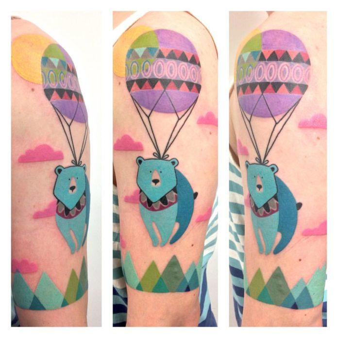 An adventurous bear takes to the skies in a colorful hot air balloon in this excellent tattoo by Amanda Chamfreau