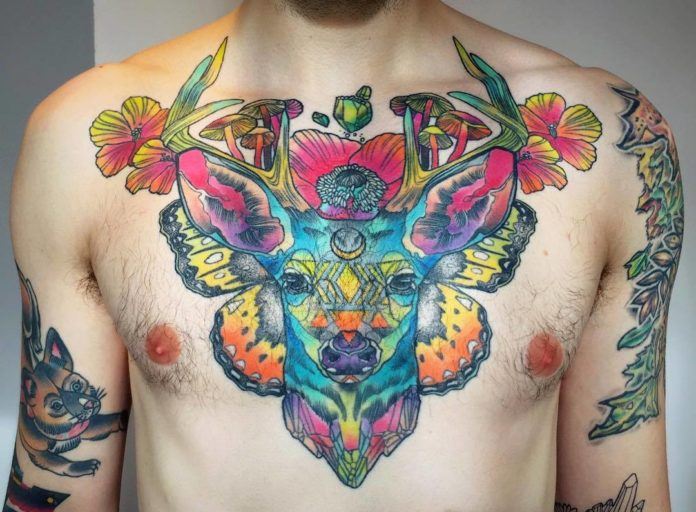 Katie Shocrylas' psychedelic tattoo of a deer features the animal posing with poppy flowers and magic mushrooms on a background of butterfly wings.