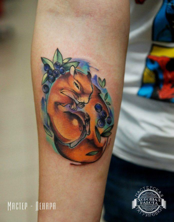 Lenara Nerpa tattoos a sleepy squirrel surrounded by blackberries in this adorable tattoo