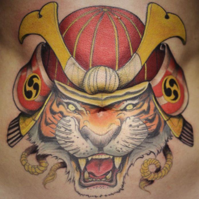 Tattoo artist Ben Shaw makes this snarling tiger a samurai warrior by giving it the traditional helmet of Japanese warriors.