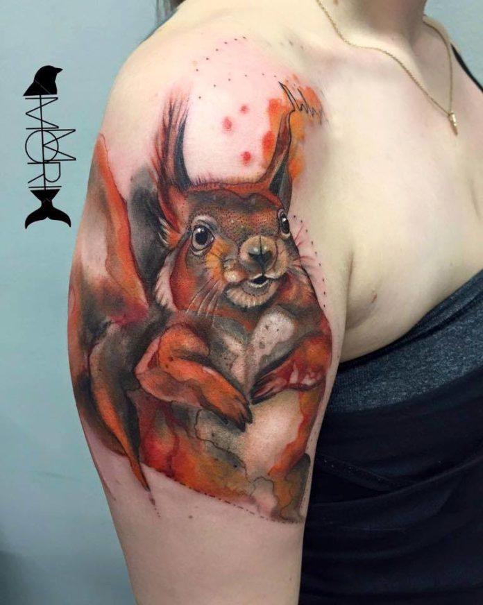 This cheeky squirrel looks like he's about to tell a dirty joke in this colourful tattoo by Mo Mori