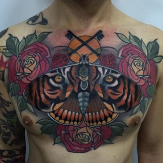 This incredible chest tattoo by Rodrigo Kalaka is a beautifully executed pun on the name of the tiger moth