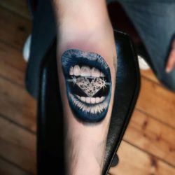 Turkish tattoo artist Jefree Naderali will wow you with this design of a woman's mouth biting down on a diamond.