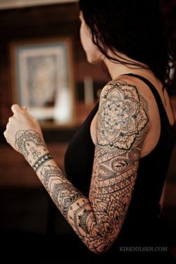 Tattoos for girls often feature a strong feminine element like the flower of life mandala at the top of this tattoo sleeve by Kirk Nilsen. This lacy sleeve will be worn for eternity by this lucky client of Nilsen's.