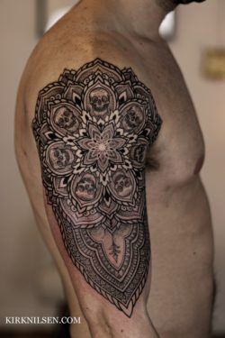 Kirk Nilsen's black ink tattoos often feature a distinctly Buddhist influence, as can be seen in the lotus flower in this tattoo design