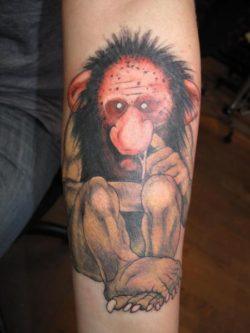 This tattoo shows one of the ugly, nasty trolls from the gnomes books picking his nose