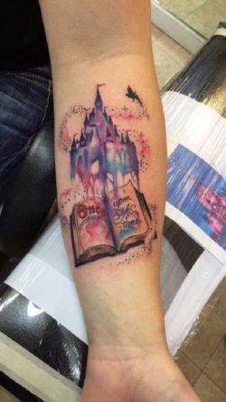 A fairy tale castle rises up out of this book tattoo, a symbol of the magic that books contain for the tattoo lover
