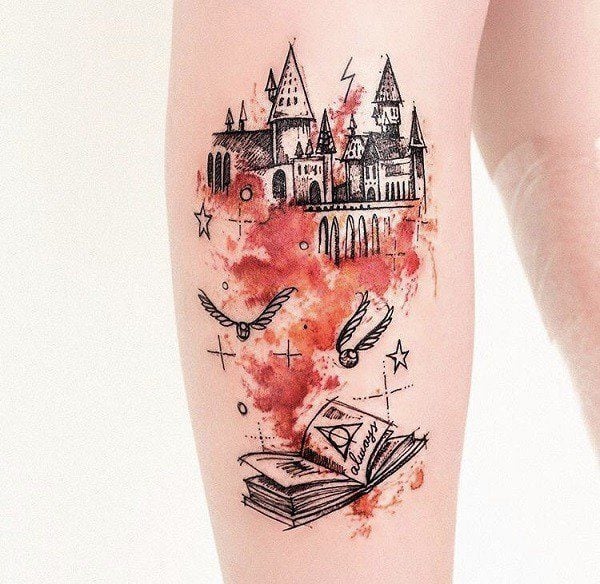 A vision of a fantasy town emerges from a book in this magical tattoo