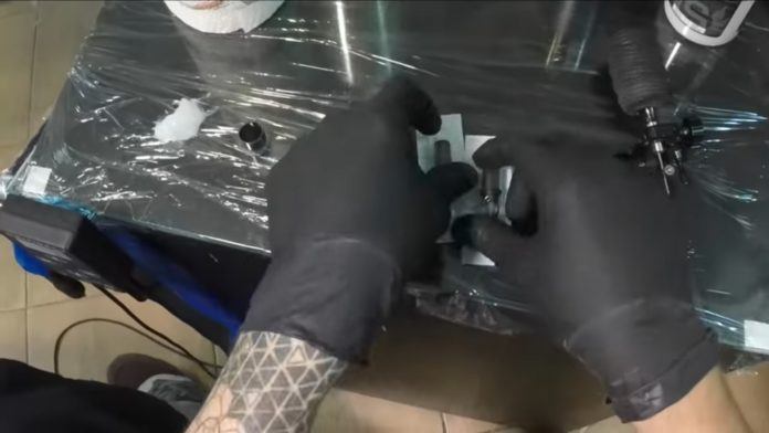 Here is Florin Zaharia setting up his workstation before starting to ink a beautiful lotus flower tattoo design