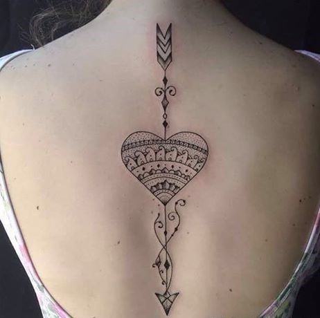 Tattooer José Audi has lent his uniquely decorative art style to this cupid's heart and arrow tattoo