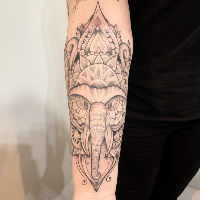 This dot work tattoo by José Flávio Audi combines the wisdom of the elephant with the spiritual symbolism of mandala and lotus flowers.
