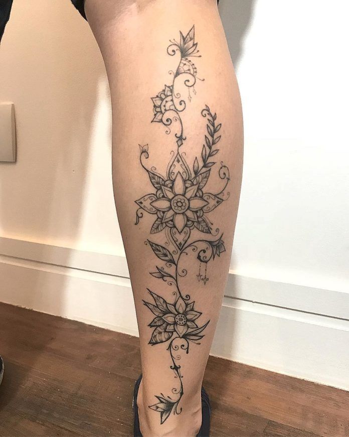 This stunning mandala calf tattoo by José Flávio Audi boasts beautiful leaves, spirals, flower buds and delicate jewels