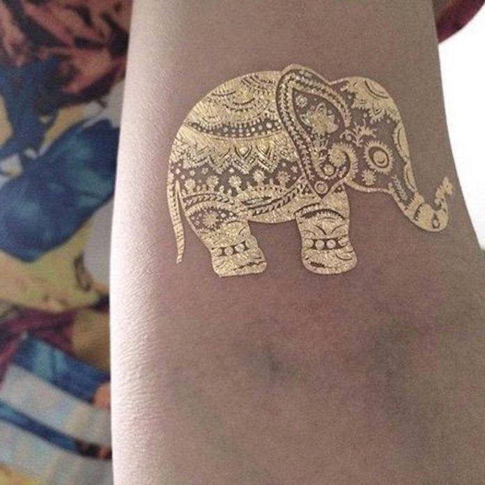 Gold ink has been used to give this temporary tattoo of an elephant with Hindu patterns a playful appeal