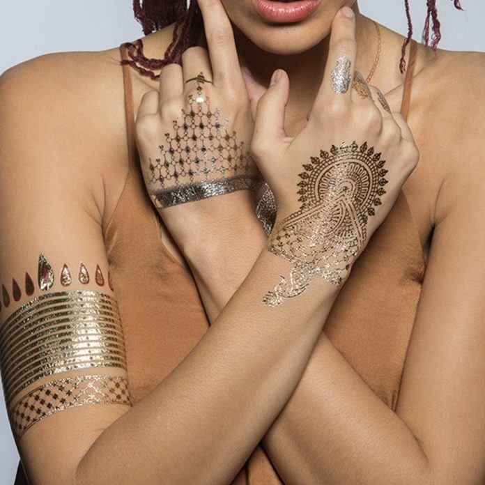 Metallic temporary tattoos can be worn in place of jewelry at music festivals and parties and can complete an outfit of a hippy queen