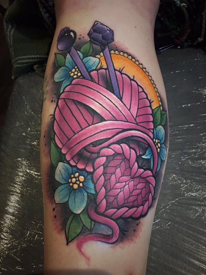 Tattoo artist Leah Moule has added hearts and flowers into this colorful knitting tattoo to add to the feminine appeal of the tattoo design