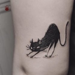 This tattoo by Daria Rei is of a nightmare kitty waking up from a dream in which it probably killed and ate all the mice ever, everywhere