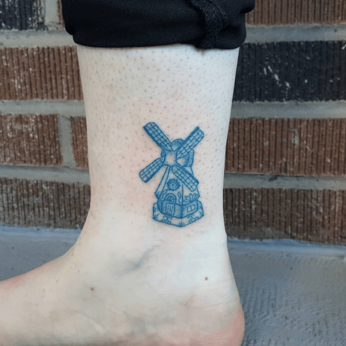 Kristina Stepanic has hand poked this Dutch windmill in a Delft Blue style, even adding tiny painted flowers to the windmill's sides
