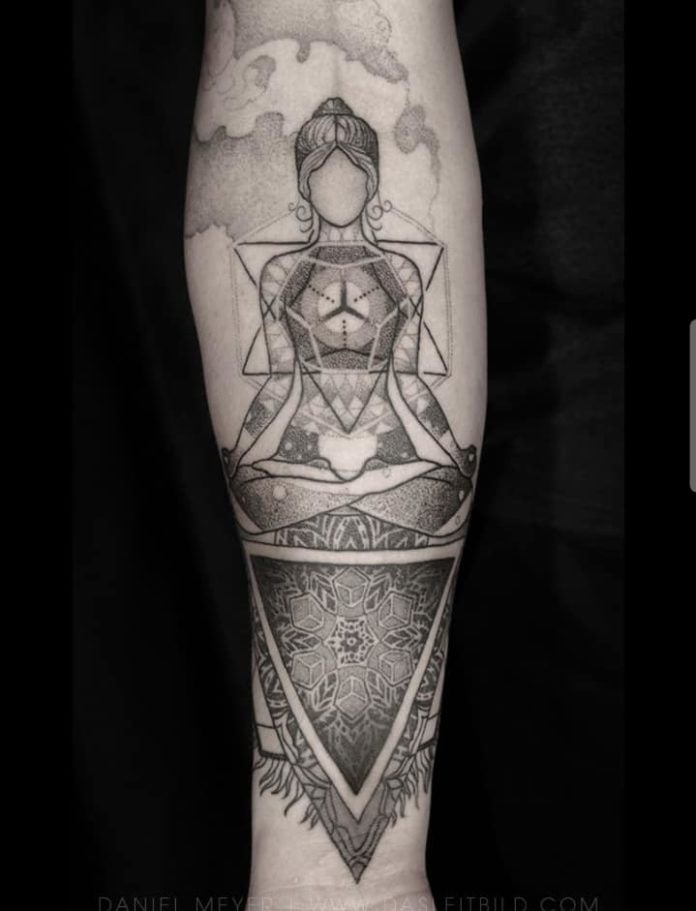 This esoteric tattoo features a beautiful woman in a seated meditation pose surrounded by sacred geometry and mandalas