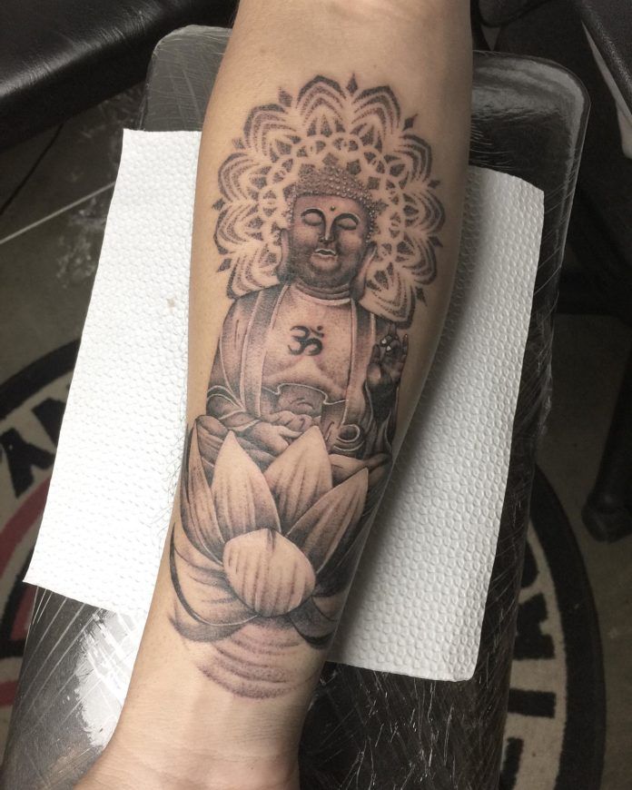 Buddha sits in the Lotus Position upon a lotus flower in this black ink meditation tattoo. On the Buddha's chest we see an Ohm Sign. Chanting "ohm" slowly and peacefully can help to clear the mind of intrusive thoughts.