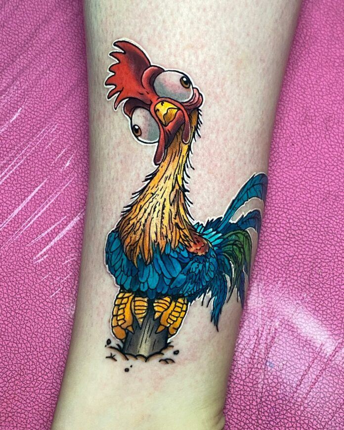 Tattoo artist Brent Goudie has given this cartoonish tattoo design of Heihei the rooster from Moana a sticker effect by outlining the design with white tattoo ink, like the border of a sticker. Even though the white ink will fade in intensity; it will still help to make this Heihei tattoo really pop.
