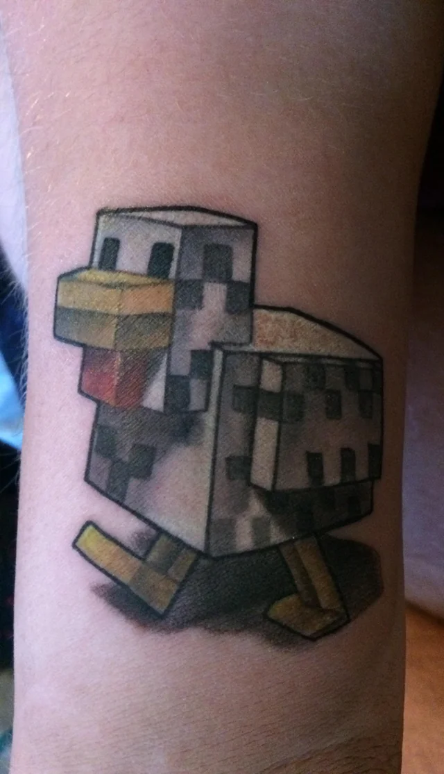 This 3D tattoo is of a blocky Minecraft chicken, completed with its duck face