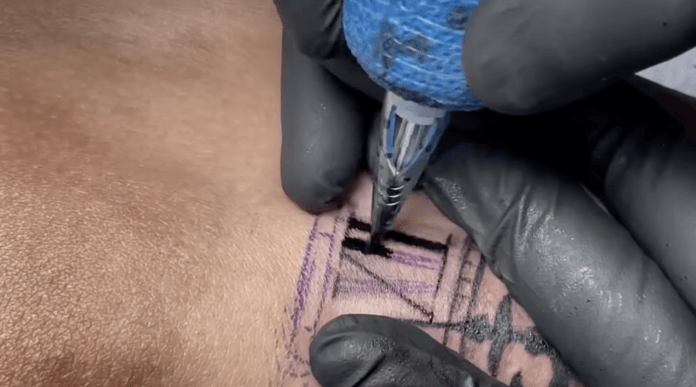 Here's Alex Konti inking the Roman numeral twelve on the broken clockface of this tattoo design